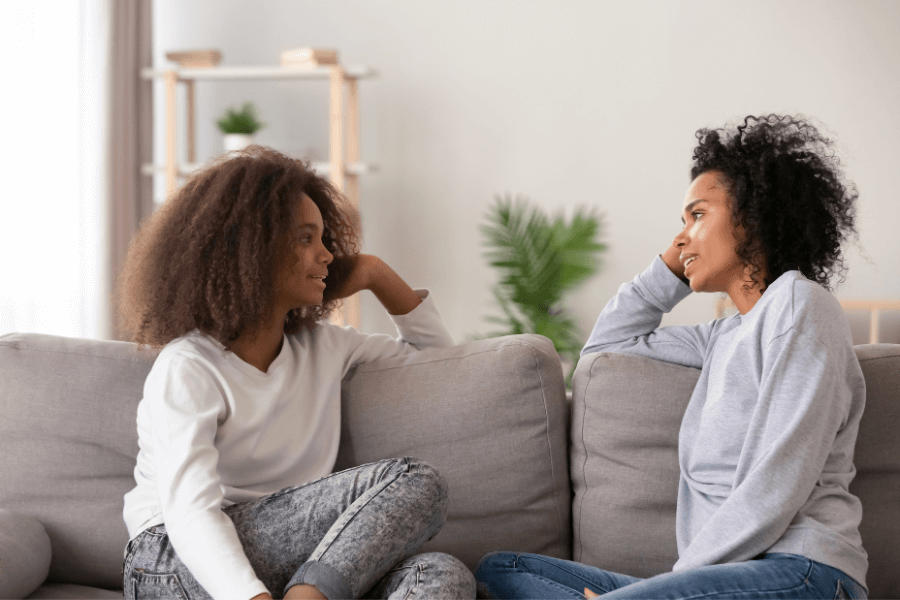 Mother and daughter interacting on the sofa